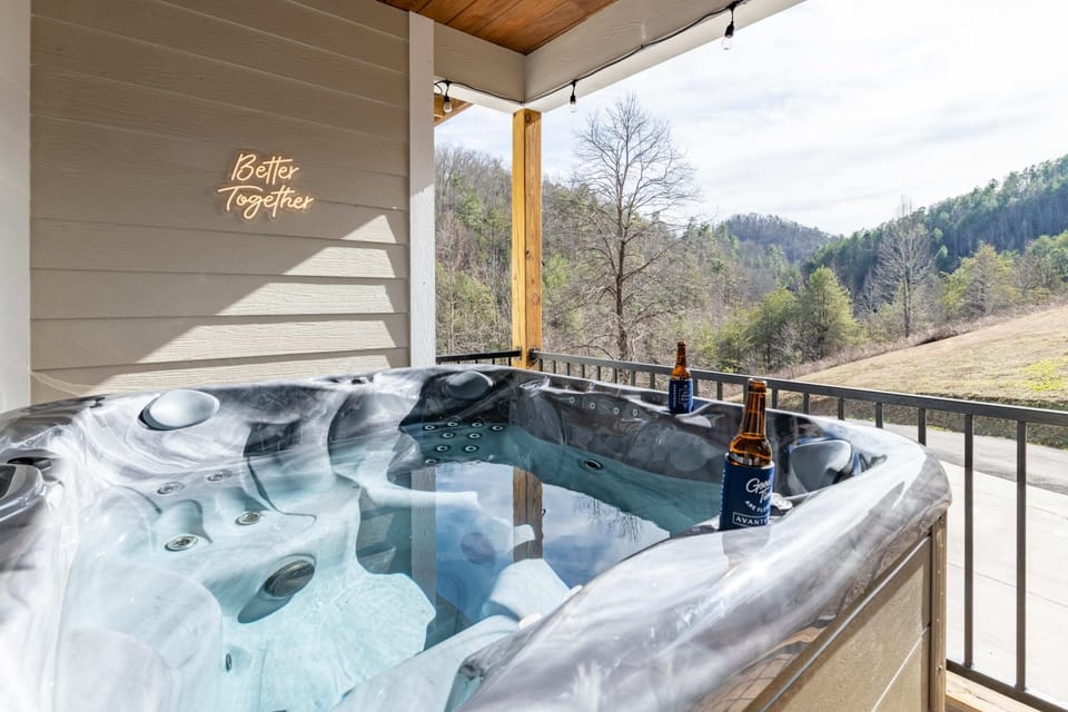 Soak in the hot tub on the large deck while taking in panoramic views of the surrounding natural beauty. - The Regal - Sevierville, TN