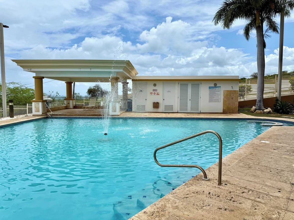 The inviting pool with steps and a handrail for easy access.