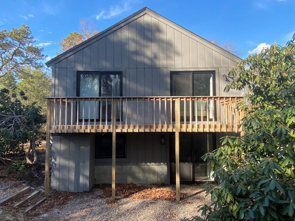 Side of the house with deck access for two of the bedrooms