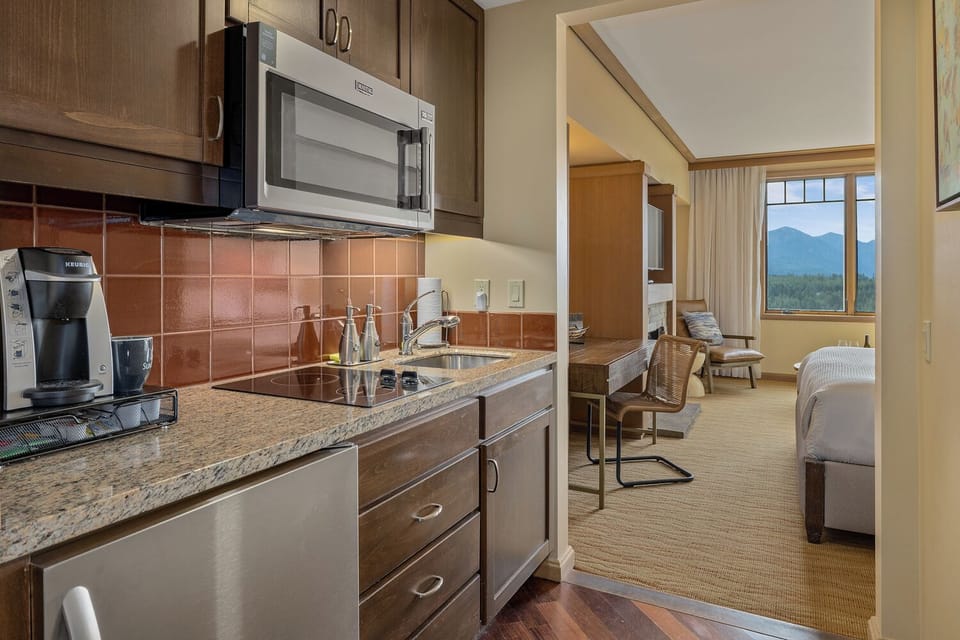 Microwave, cooktop, refrigerator, pots, pans, dishes, drinkware...it's all here.