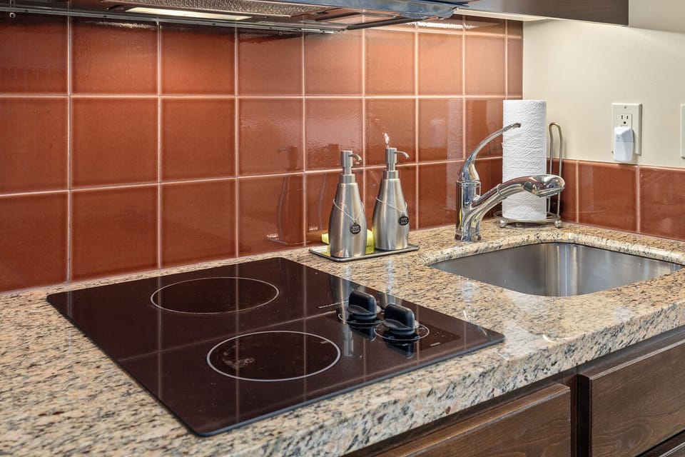 Luxury convenience  cooktop, soaps, towels, dish cloths, knives & serve ware. 