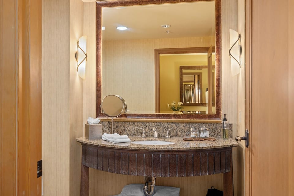 Spacious vanity offers mag mirror, Kleene, hairdryer, soap, QTips & cotton balls