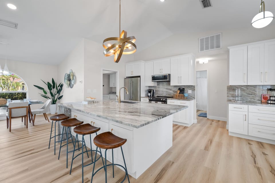 Our fully-equipped kitchen features ample seating around the island, perfect for casual breakfasts or entertaining while you cook.