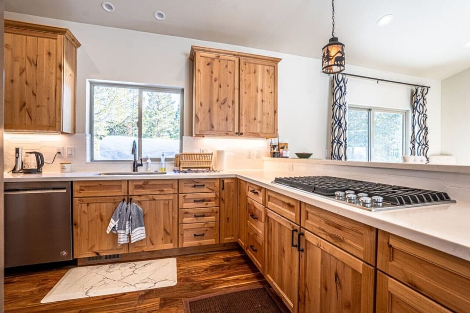 Modern equipped kitchen with 3 different coffee makers, dishwasher, stainless steel sink and more.