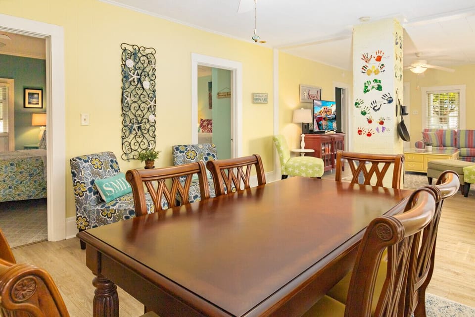 Dining area is in between the kitchen and the living room. Patio door is next to table too.