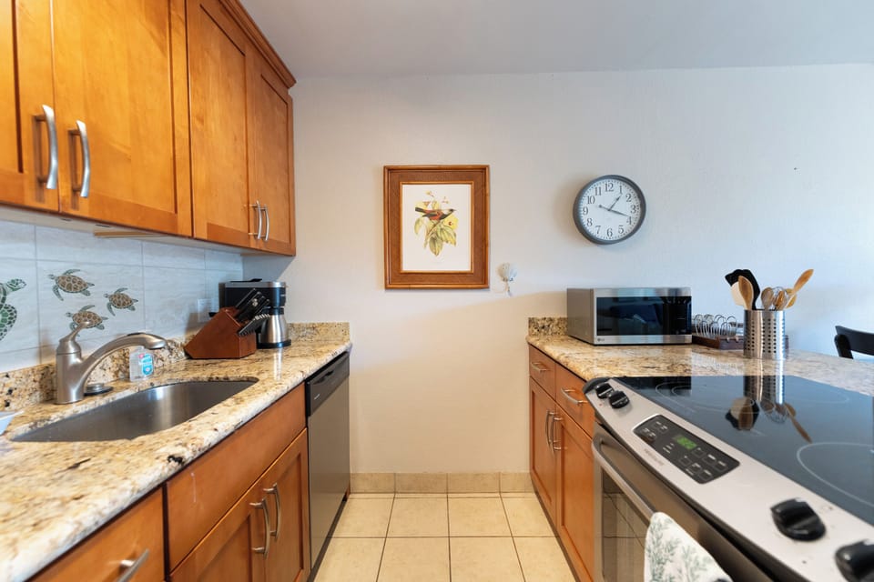 Fully-equipped kitchen with electric stove, Keurig, and microwave
