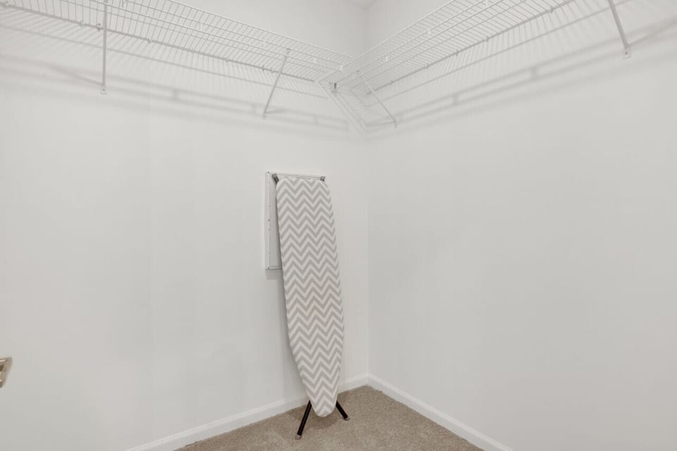 Minimalist iron stand, the perfect spot to hang clothes neatly and stay organized during your short-term rental stay.