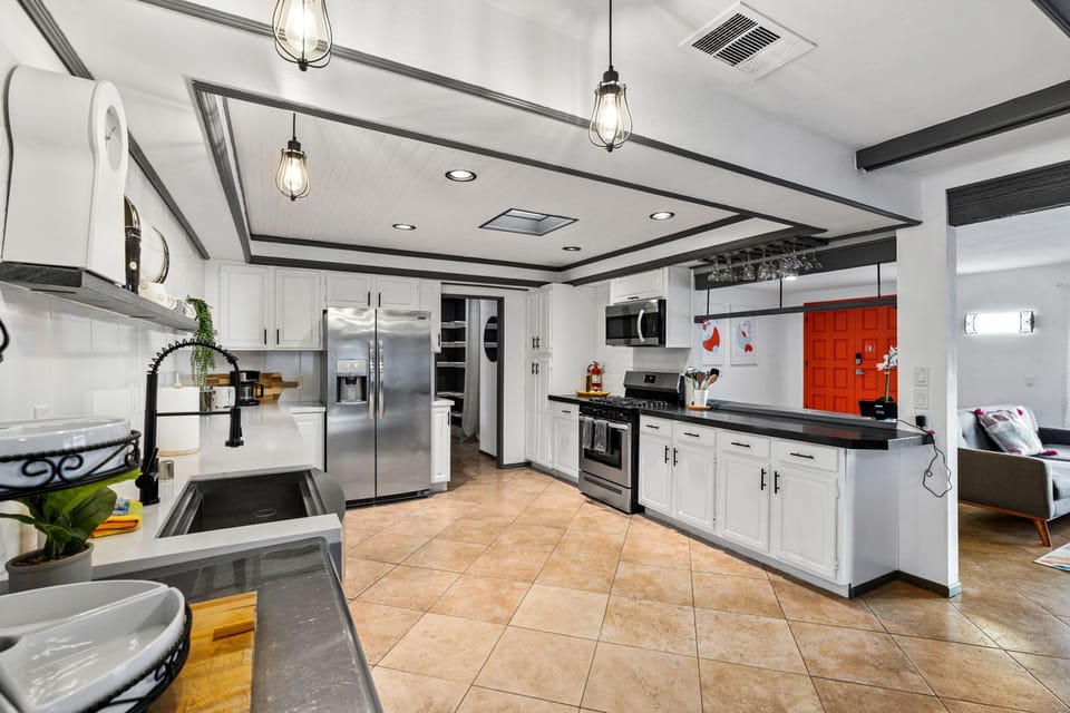 Kitchen is equipped with stainless steel appliances and cooking basics. 