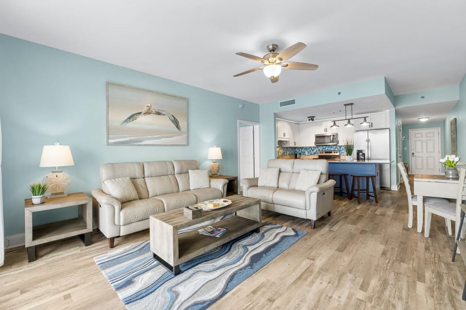 Open-concept living area with coastal-inspired decor and modern kitchen.