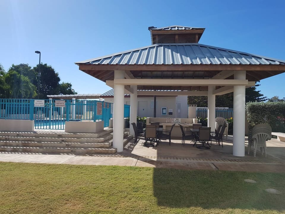 Relax and unwind in the shaded outdoor dining area beside the pool