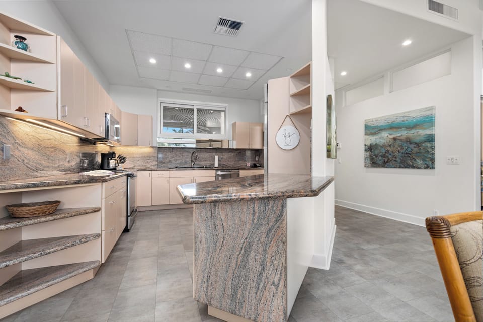 Your fully equipped kitchen gleams with elegant granite counters and modern appliances, perfect for whipping up memorable vacation meals in style and comfort.