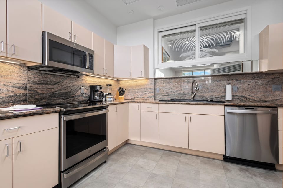 Your fully equipped kitchen features modern stainless appliances, elegant granite counters, and plenty of cabinet space—perfect for preparing meals at home during your stay.