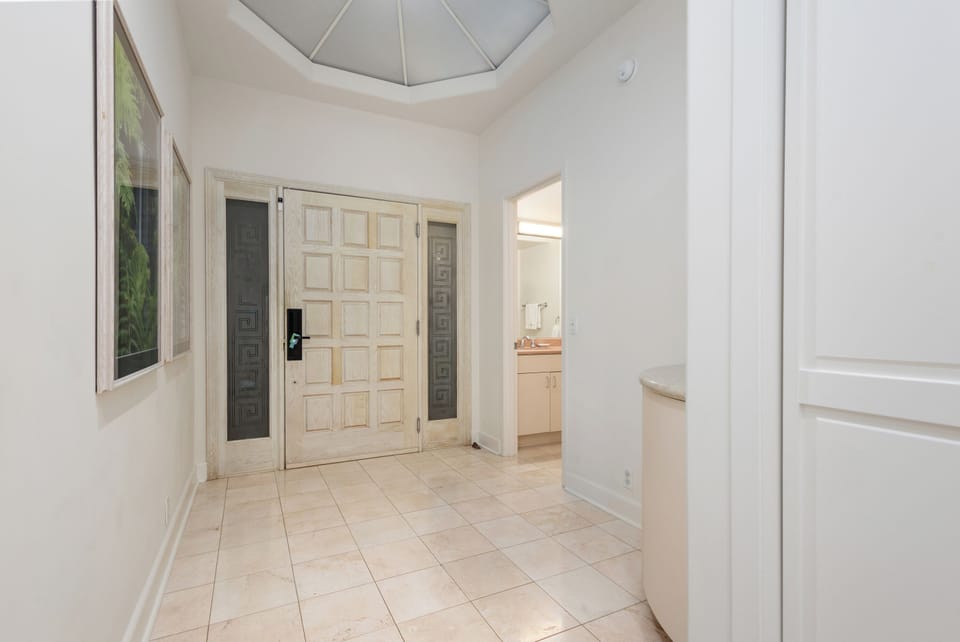 Bright entryway welcomes you with soaring vaulted ceilings and elegant tile floors, setting a welcoming tone for your stay.