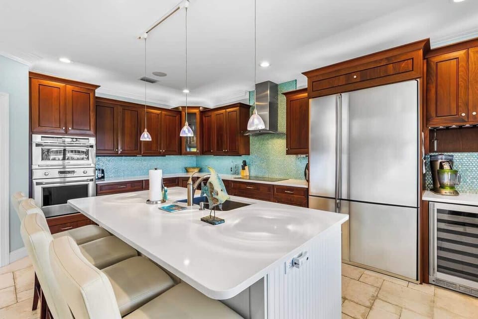 Large open kitchen with bar seating for 3