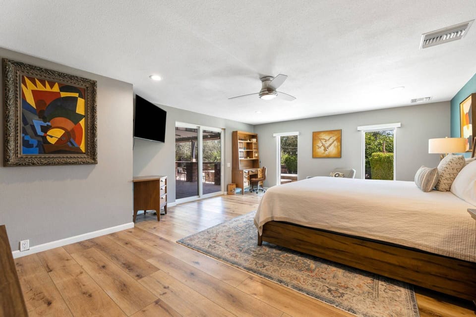 Main Bedroom has a King Bed, TV, and Ceiling Fan