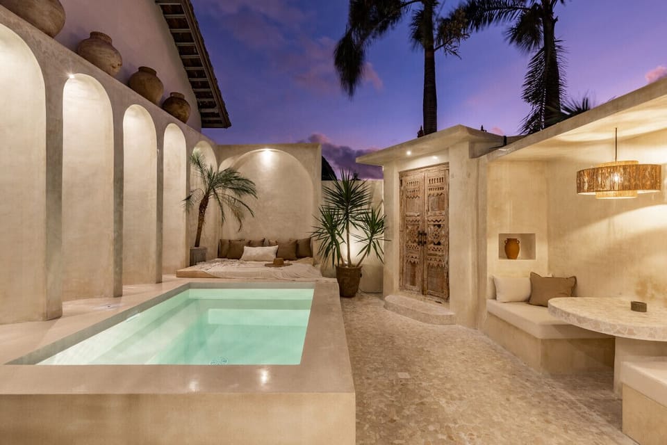 Evening serenity at the villa: Palm shadows dance across the warm glow of a luxe private retreat.