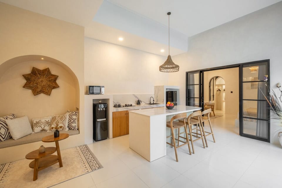A spacious villa kitchen with sleek design and direct access to comfortable bedrooms.