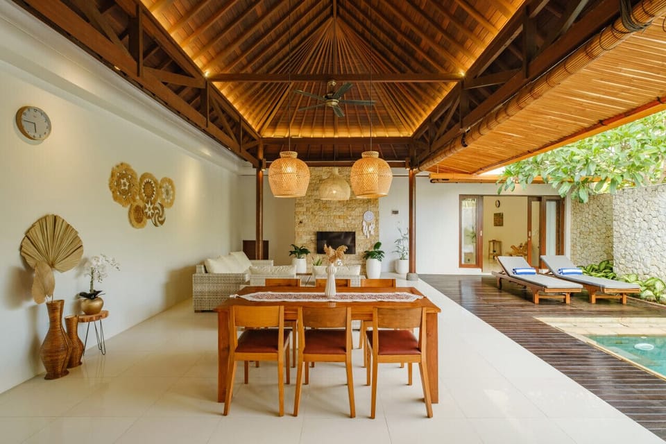 Cozy lounge with a pool view and natural light.