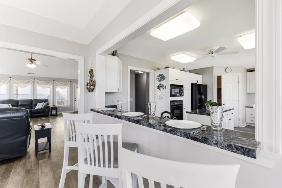 The kitchen features a breakfast bar for casual meals and gathering while cooking.