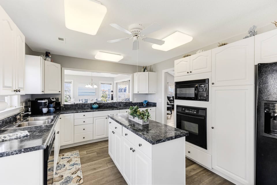 A 180-degree view of the kitchen, showcasing all the available equipment and the spacious island for your cooking needs.