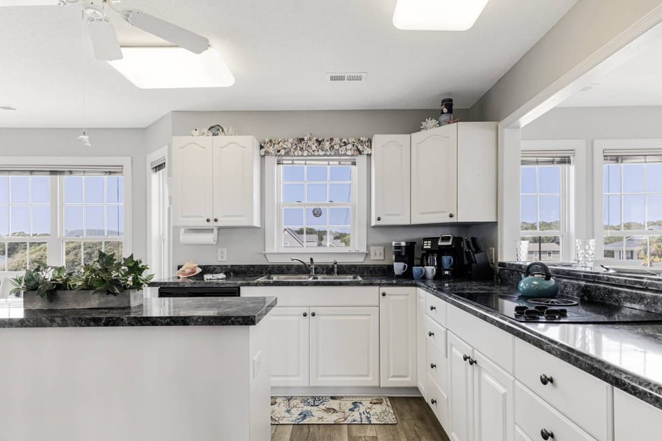 Kitchen with an island, fully equipped for your cooking needs, and a coffee maker to start your day right.