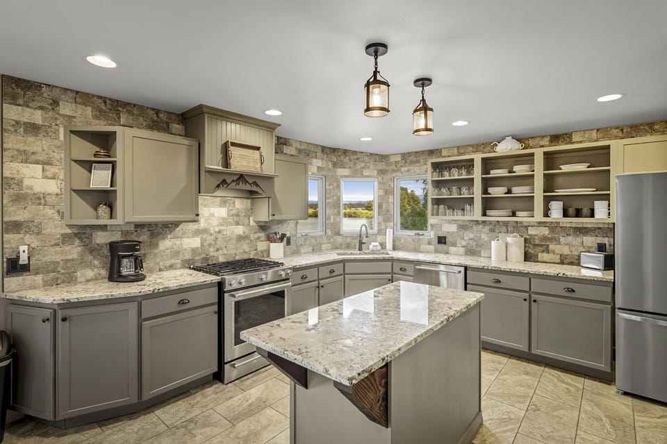 Fully equipped chef's kitchen with a large pantry, two ovens, and gas range will please the whole crowd.