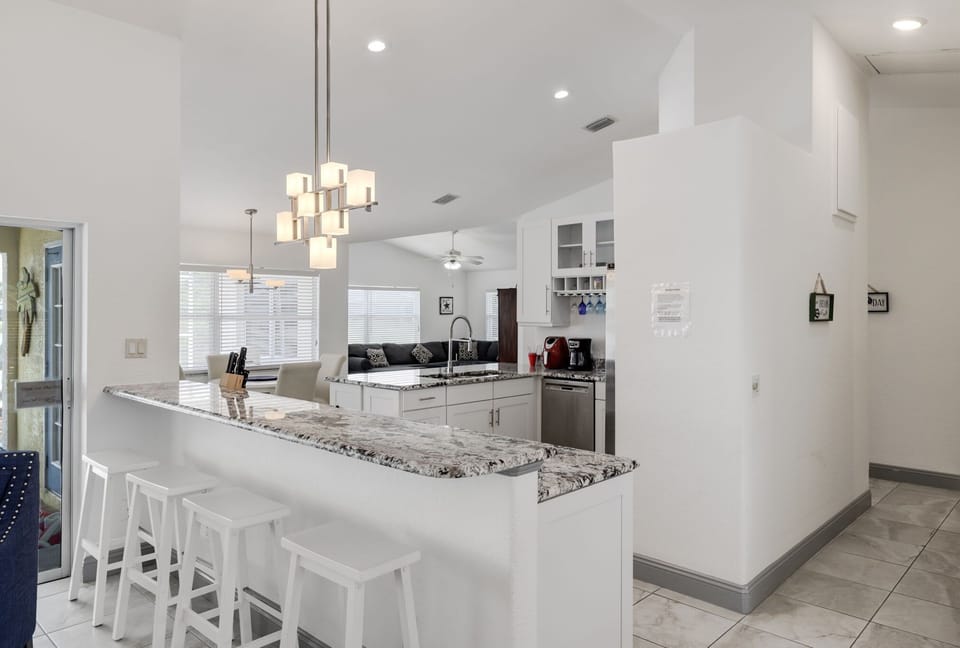 Fully equipped kitchen with breakfast bar capable of seating four guests