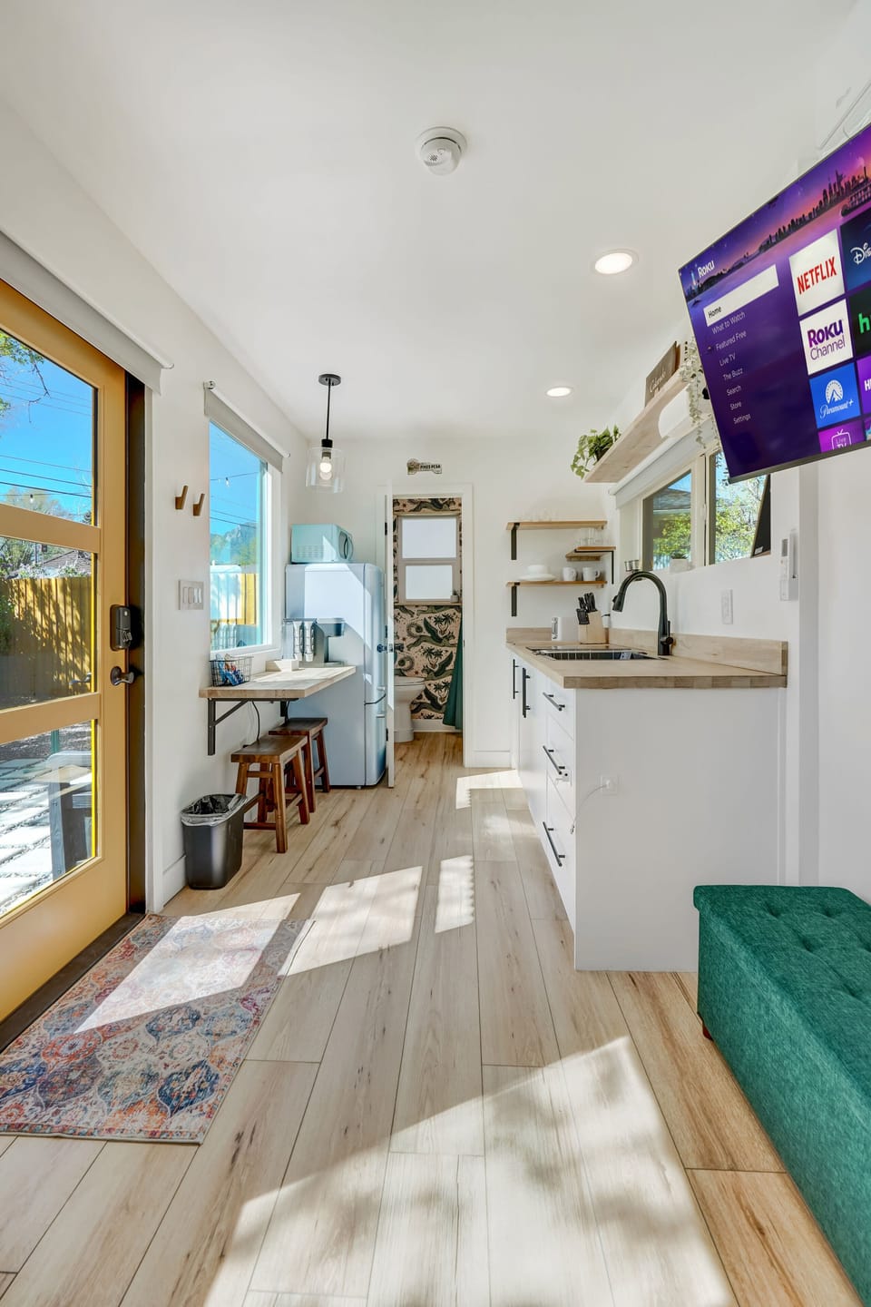 Bright and airy! The fully-equipped kitchenette has everything you need for easy meal prep, while the Roku Smart TV ensures entertainment at your fingertips.