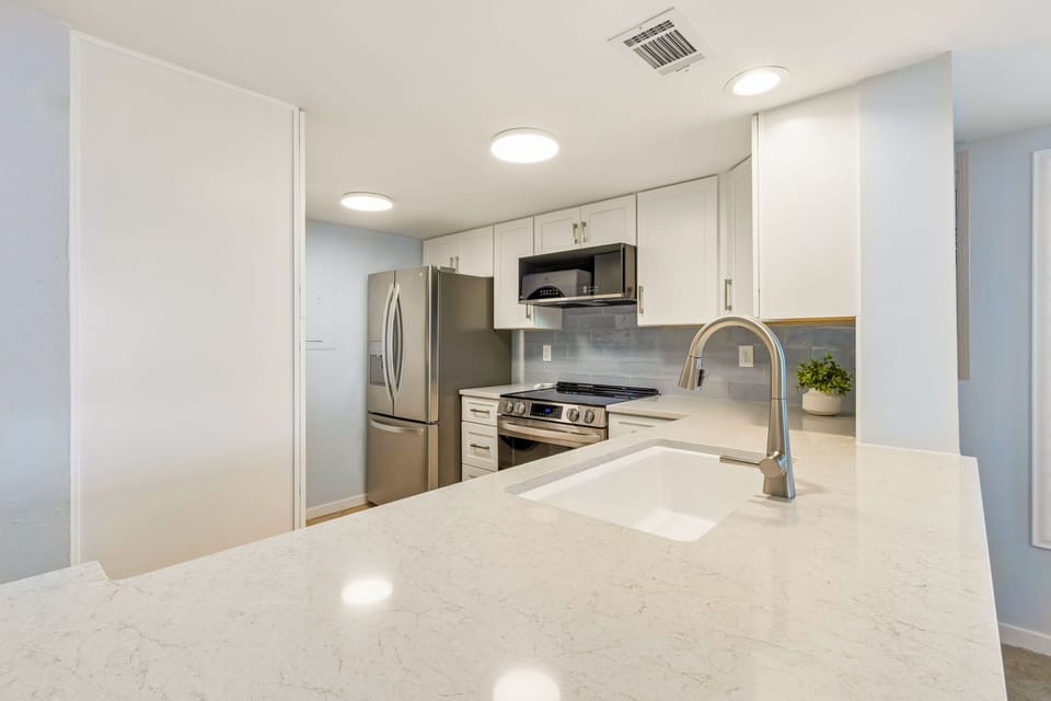 Fully Stocked Kitchen Opens to Living and Dining Area