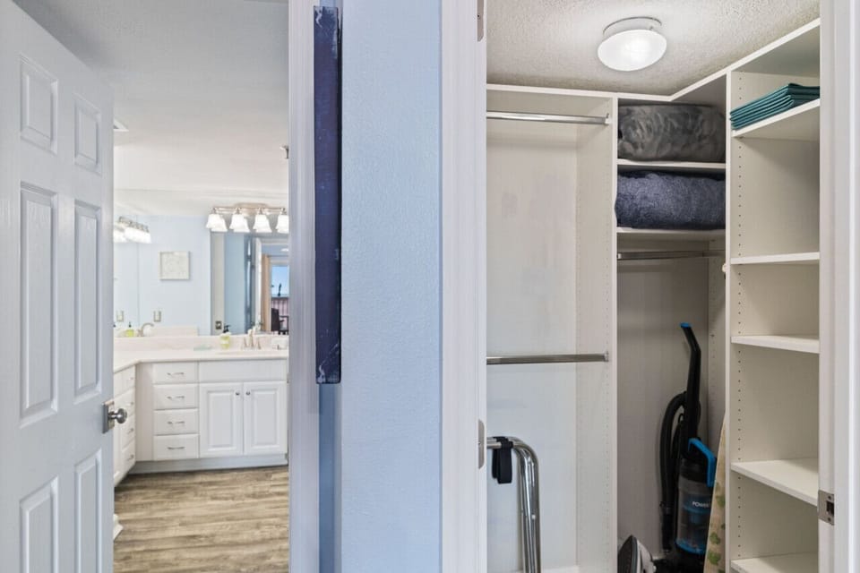 Walk-in closet w/ built-in shelving, offering plenty of space to unpack and stay organized.