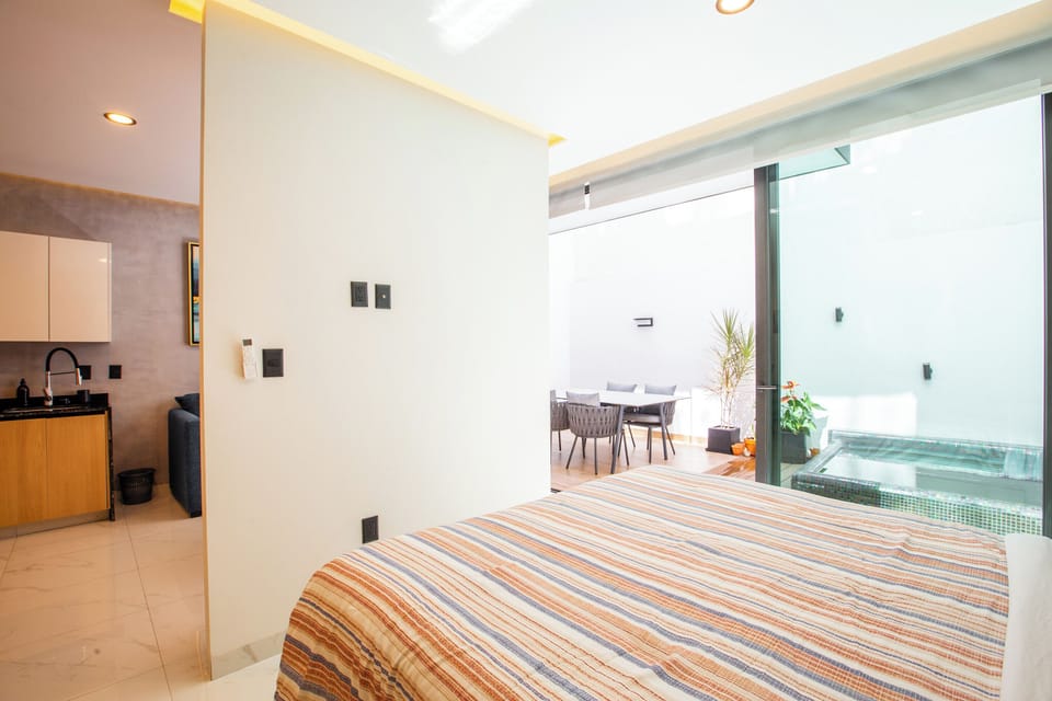 The bedroom has direct access to the private patio