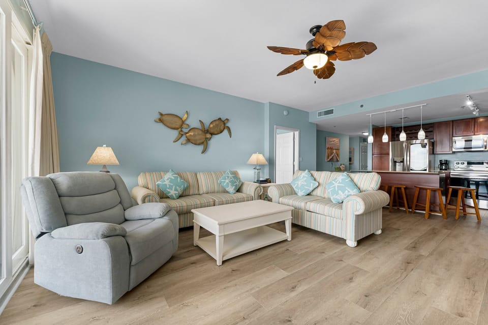 Relax in this coastal-style living room with comfortable seating and ocean-inspired decor.