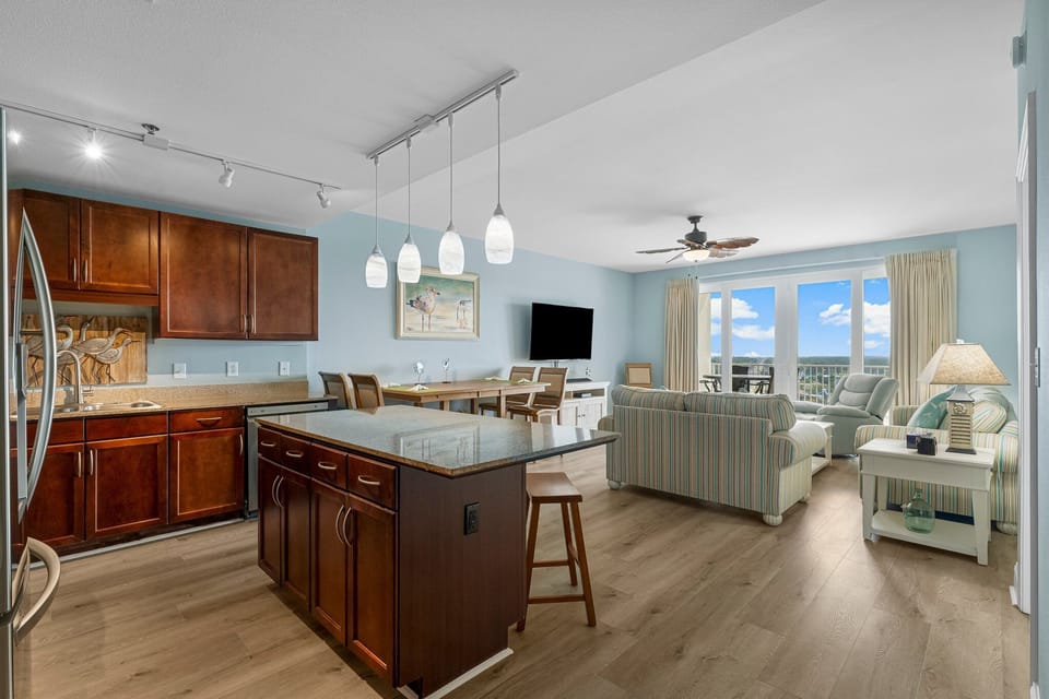Open-concept living area with a modern kitchen island and ocean views through large windows