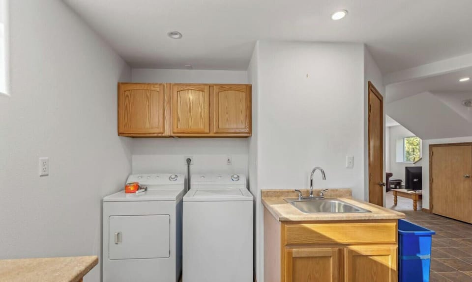Washer, dryer, and utility sink.