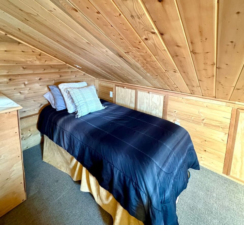 Twin bed upstairs in shared space with queen.