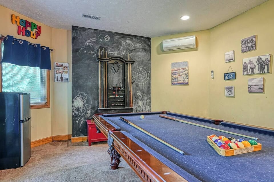 Gameroom view from couch.   Pool table and chalk board to keep score.