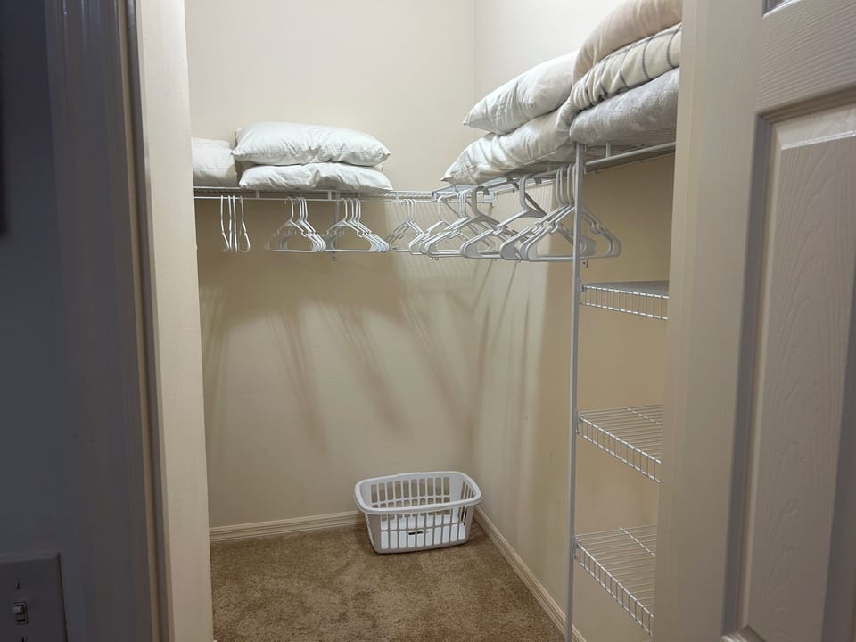 Master Bedroom Walk-in Closet with Iron and Ironing Board