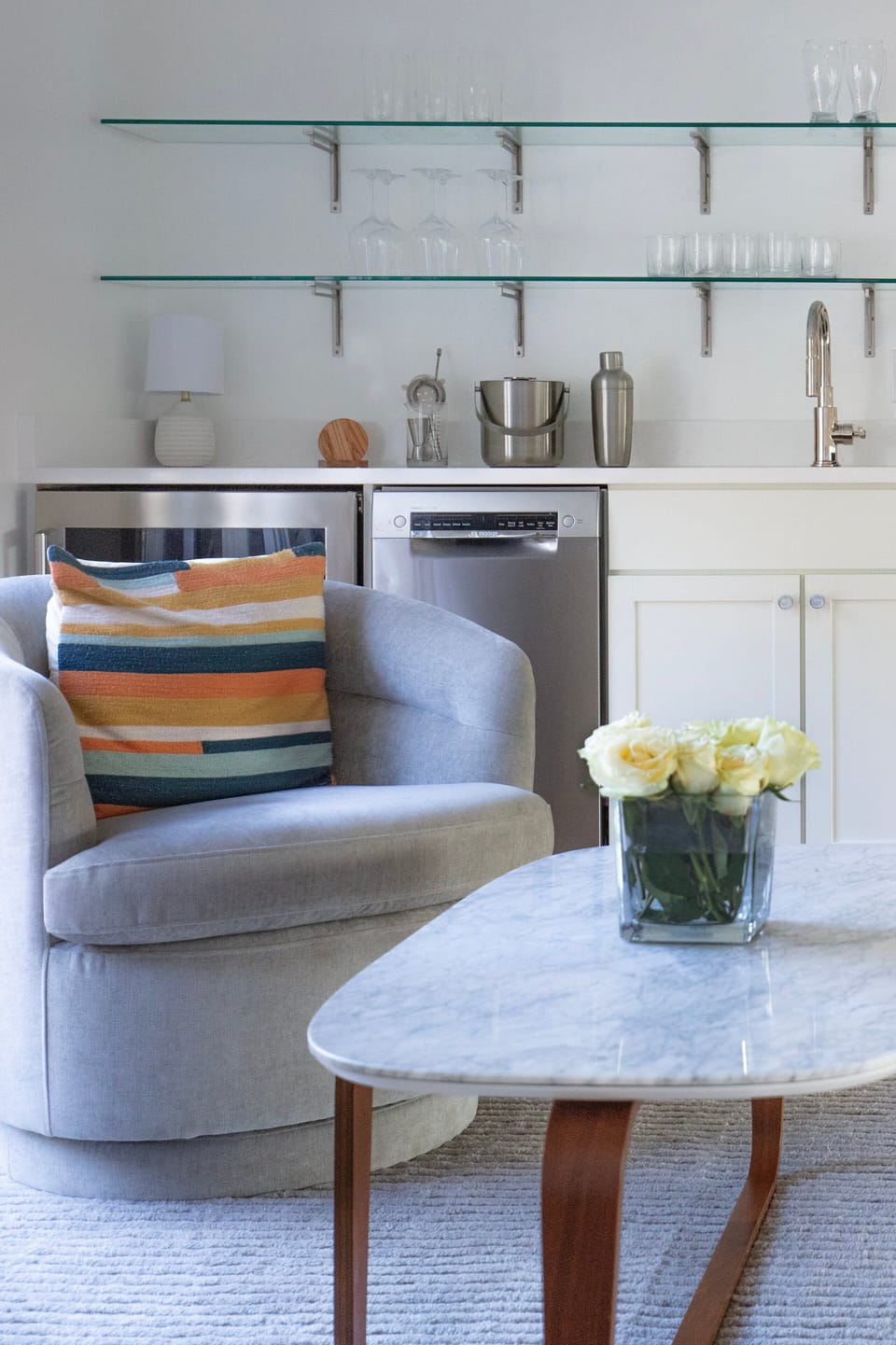 As you ascend to the mezzanine, a cozy mini lounge with wet bar awaits, offering a quiet nook for relaxation.