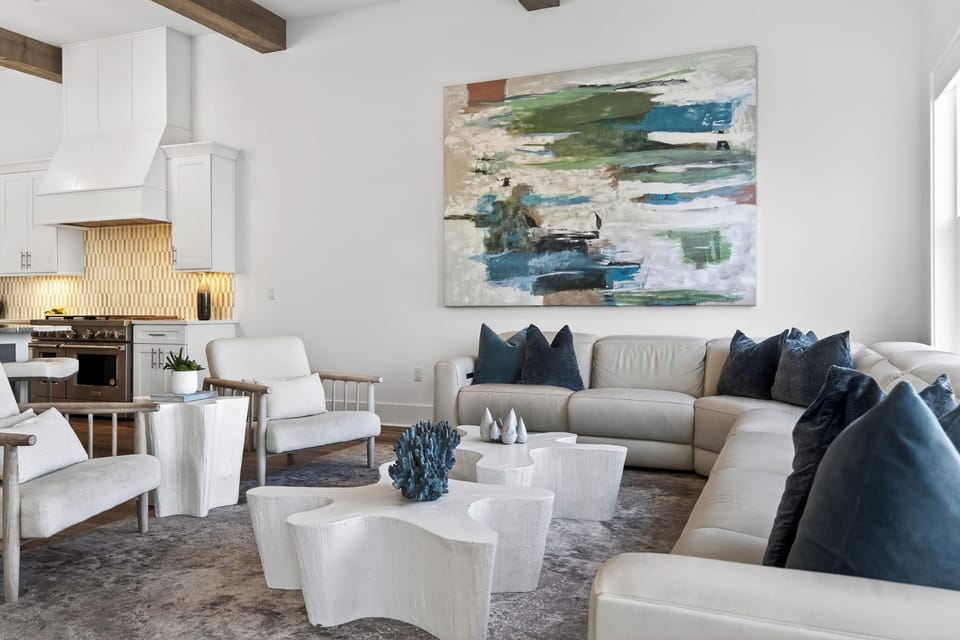 Light-filled coastal living with soaring beams, oversized sectional seating, and treetop views—your perfect spot to unwind after the beach.