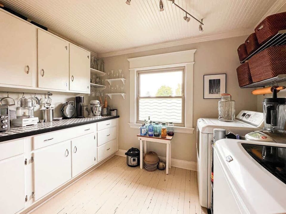 Laundry room with washer, dryer, and storage