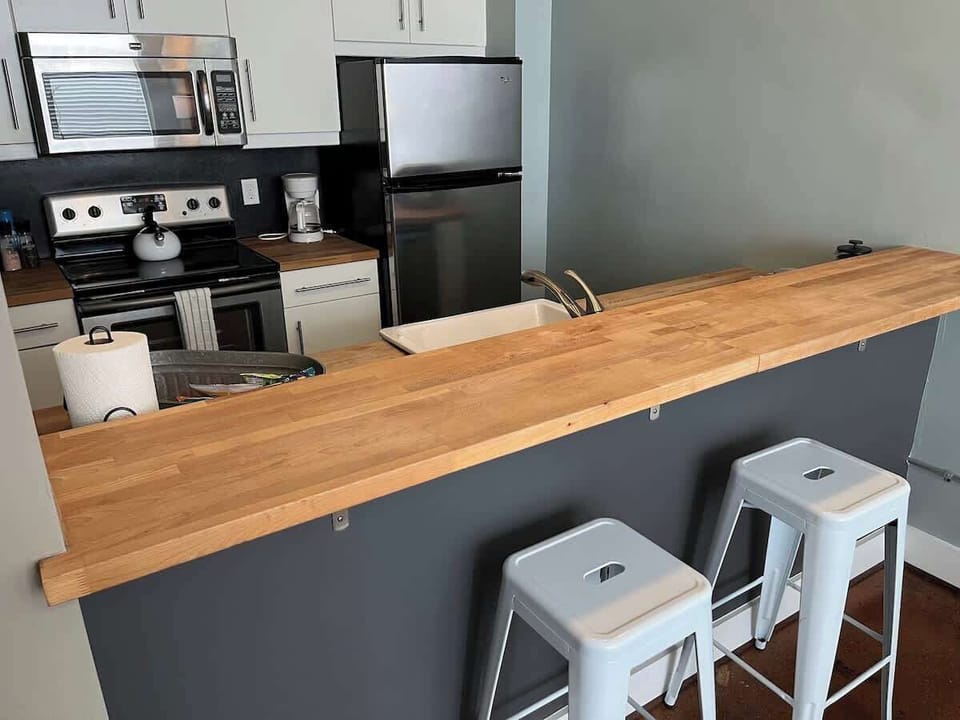 Kitchen with wooden countertop and bar stools