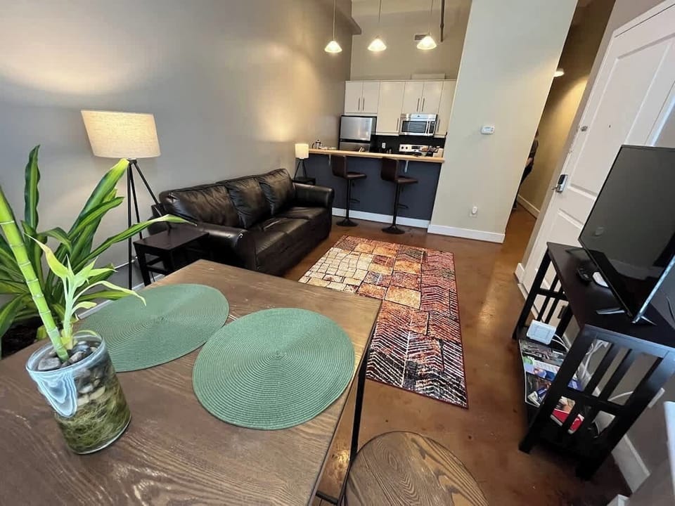 Spacious living area with cozy sofa and rug