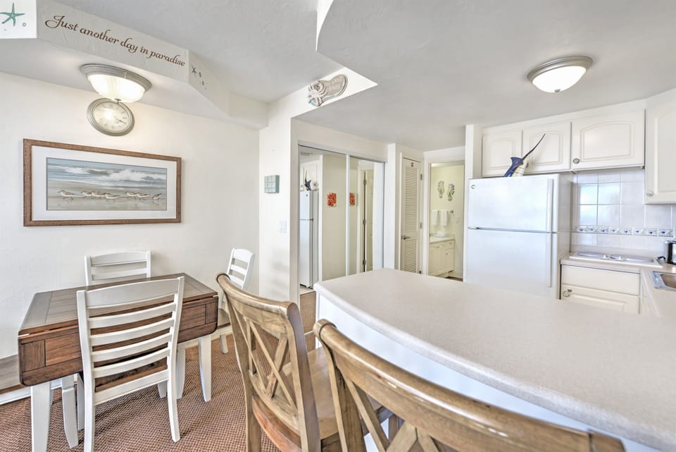 Kitchen with cookware and appliances -Dining table for four with views