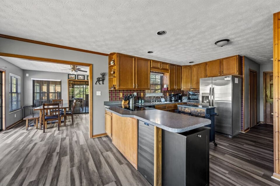 Indulge in culinary delights in your modern kitchen, complete with sleek appliances and a convenient wine cooler for your favorite vintages.