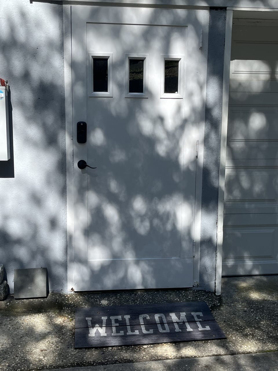 Entrance on the driveway side of the house. Keypad entry.