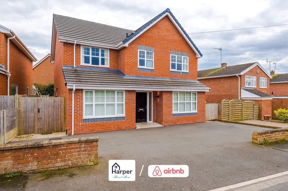 Modern brick-built detached home with large front windows.
Spacious driveway offering convenient off-street parking.
Welcoming design in a peaceful residential area.