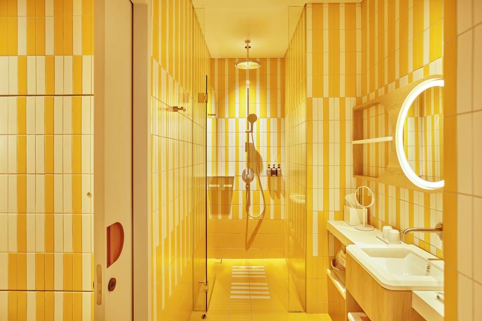 Deluxe King Pool View | Bathroom | Shower, designer toiletries, hair dryer, bathrobes