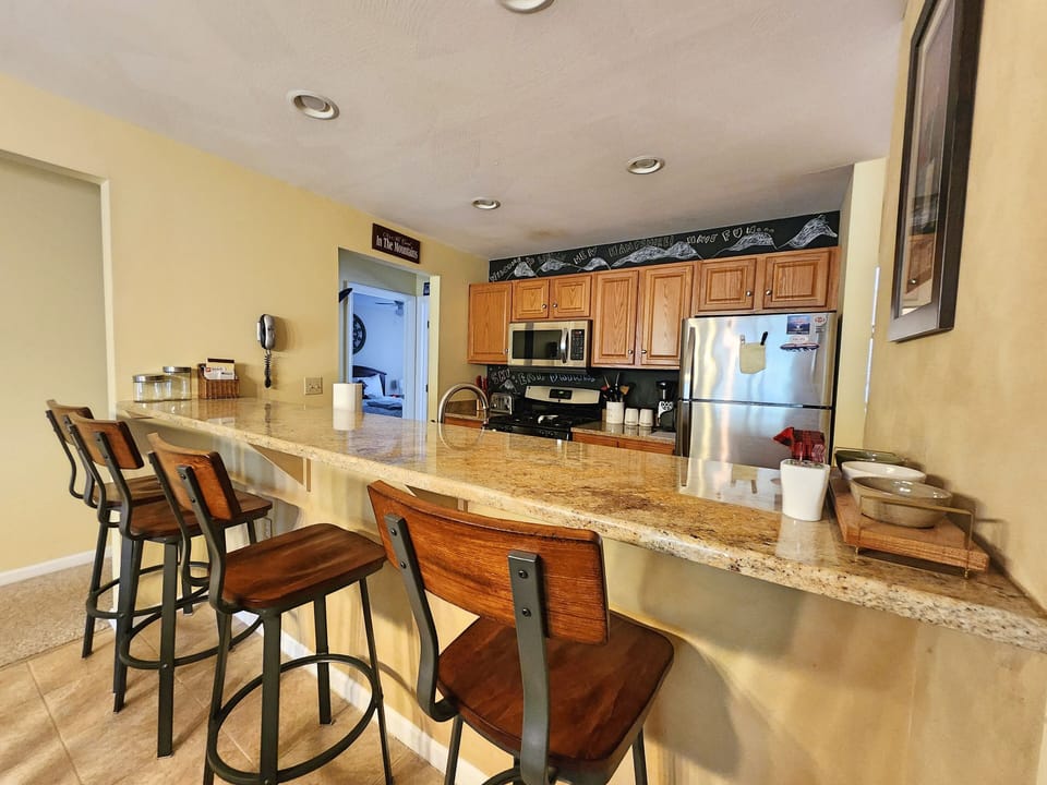 Breakfast counter seating, 2nd bedroom beyond