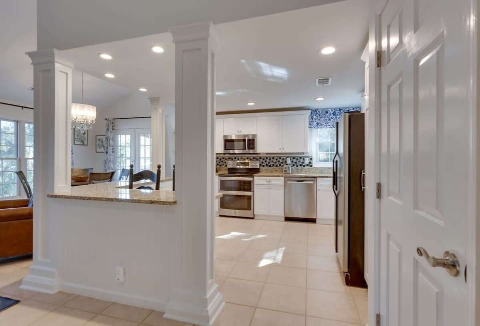 Step into your spacious kitchen with granite countertops, stainless appliances, and bright natural light streaming through large windows.