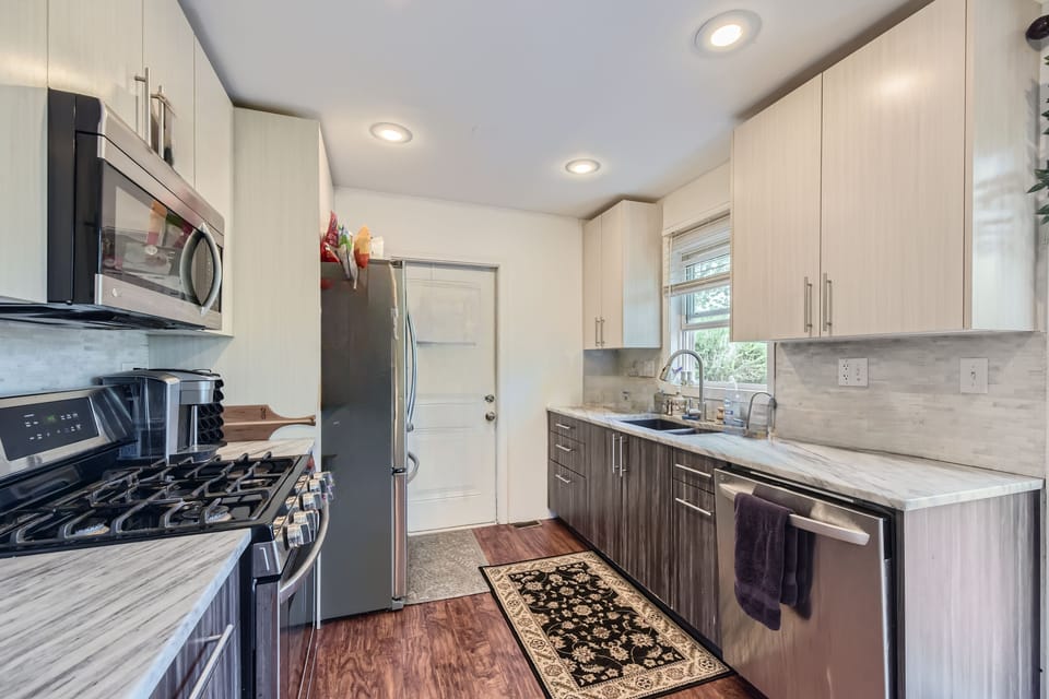 Imagine cooking your favorite dishes in this bright, modern kitchen hub.